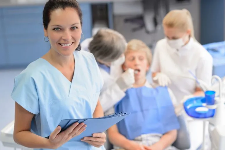 Smiling woman holding a medical chart